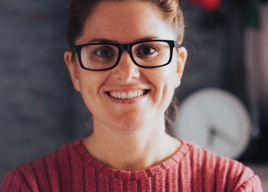 Smiling individual at Vtherapy Closing!!, St Saviour, GB wearing glasses and a red sweater.