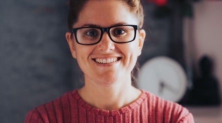 Smiling individual at Vtherapy Closing!!, St Saviour, GB wearing glasses and a red sweater.