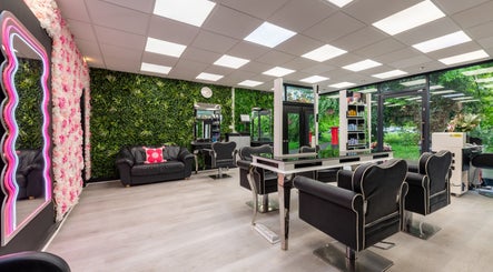 Stylish interior of Chop and Change salon in Addlestone, England, GB featuring lush greenery and modern seating.