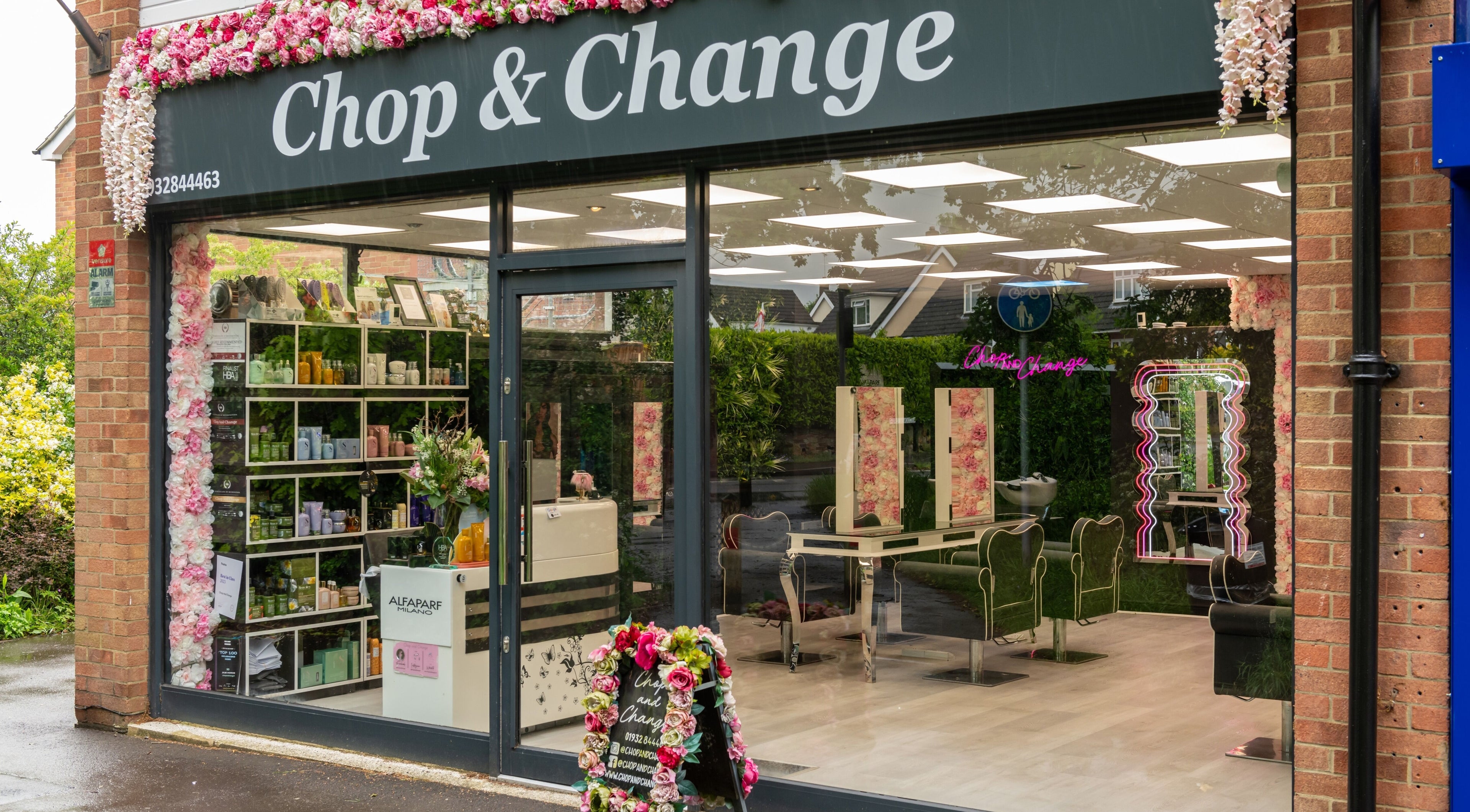 Exterior of Chop and Change beauty salon in Addlestone, England, GB with floral decor.