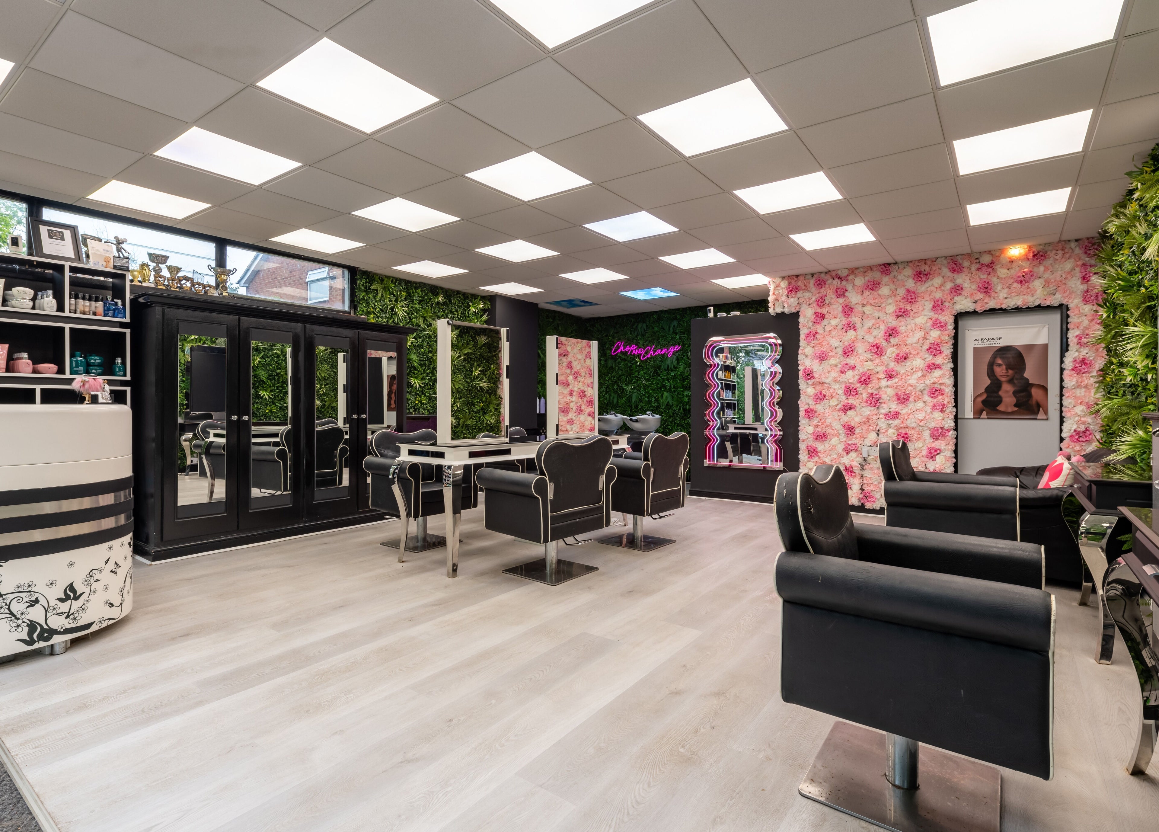 Stylish interior of Chop and Change in Addlestone, England with elegant salon chairs and vibrant decor.