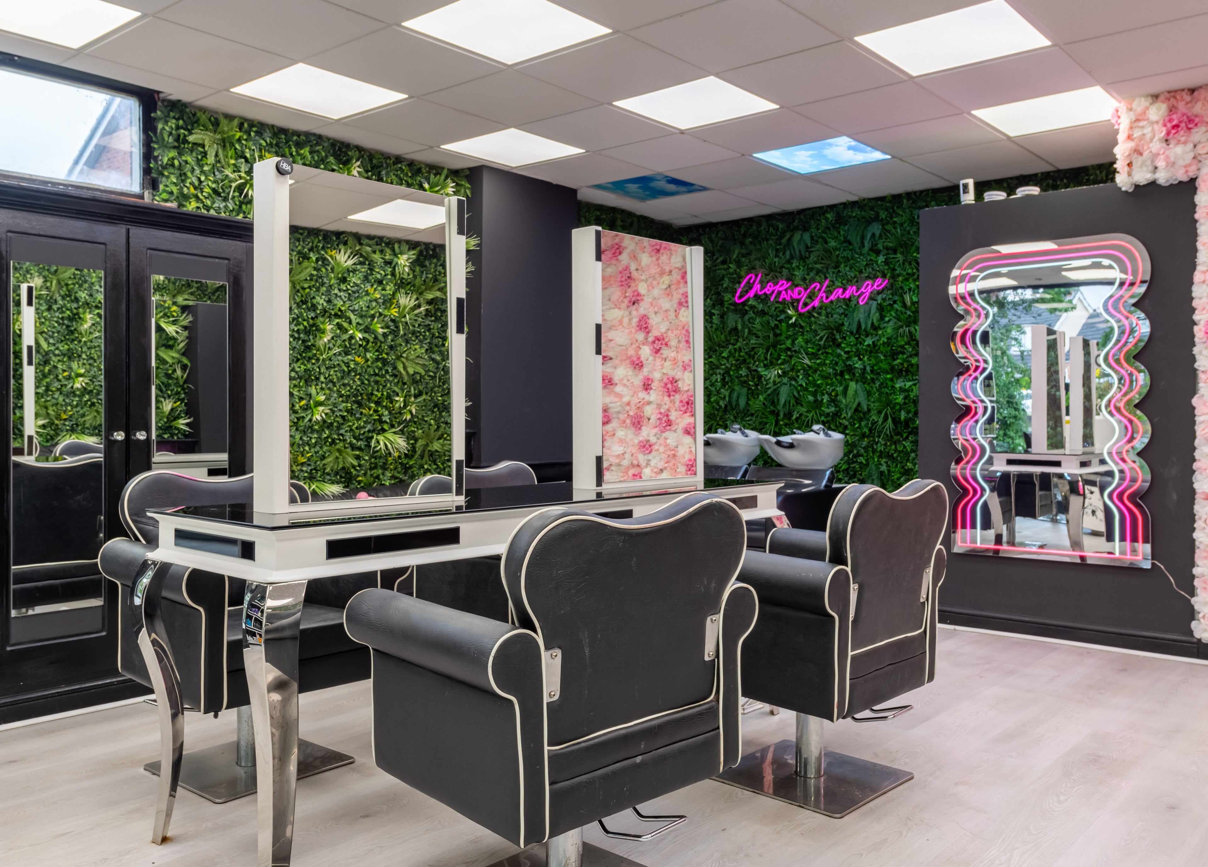 Interior of Chop and Change salon, Addlestone, England, GB, featuring stylish chairs and lush decor.