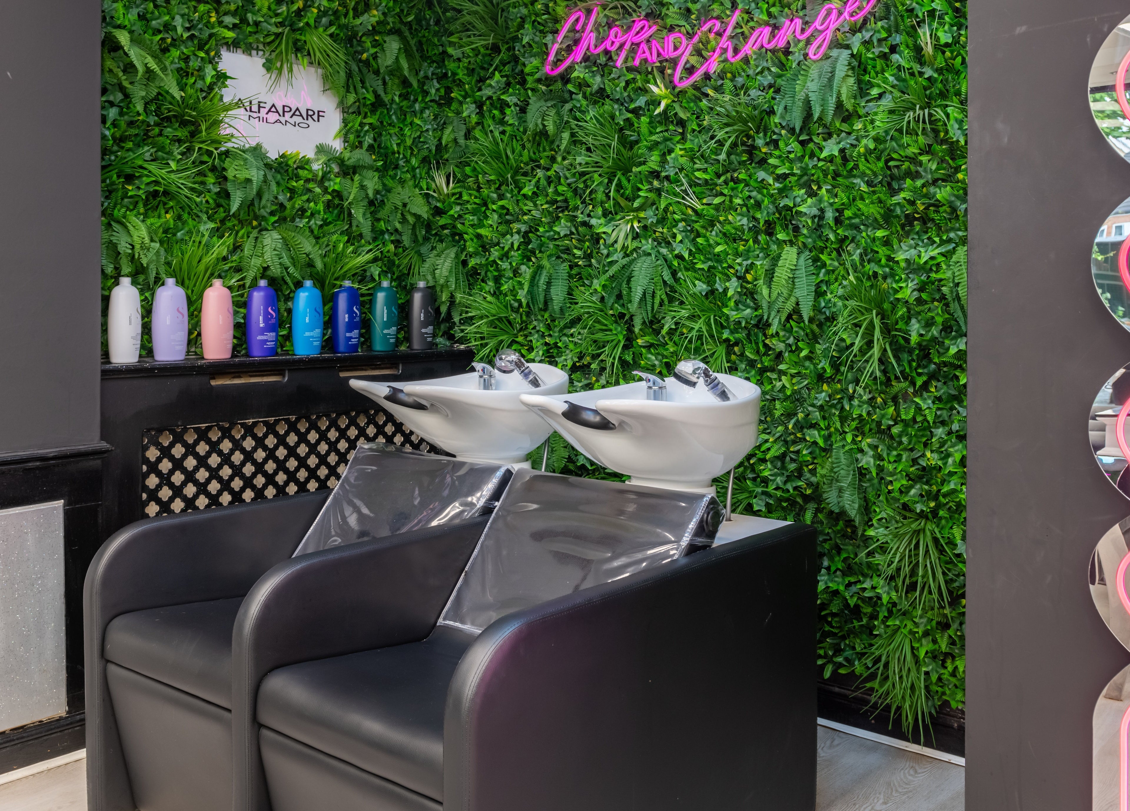 Stylish hair washing station at Chop and Change in Addlestone, England, GB with vibrant decor.