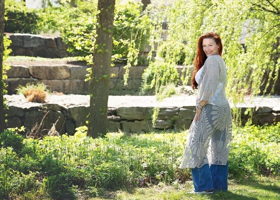 Woman in lace shawl in garden at Readings By Danielle, Hawthorne, New Jersey, US, surrounded by greenery.