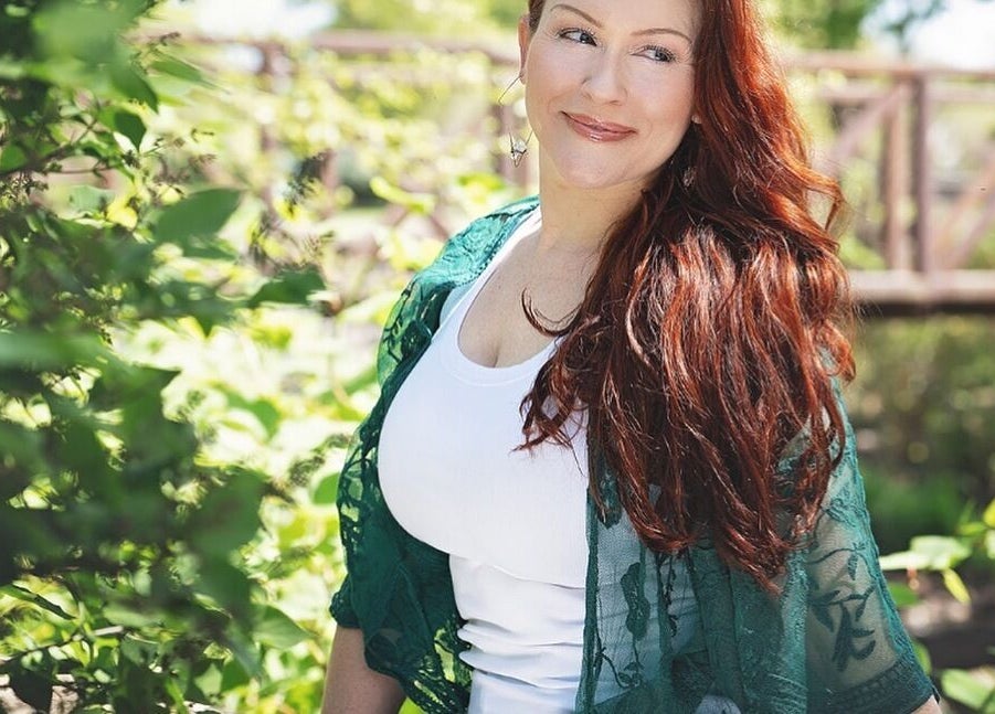 Woman enjoys nature at Readings By Danielle, Hawthorne, New Jersey, US, surrounded by lush greenery.