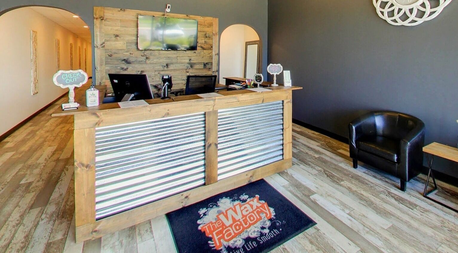 Reception area of The Wax Factory Longmont in Longmont, Colorado, US, featuring a modern rustic design.