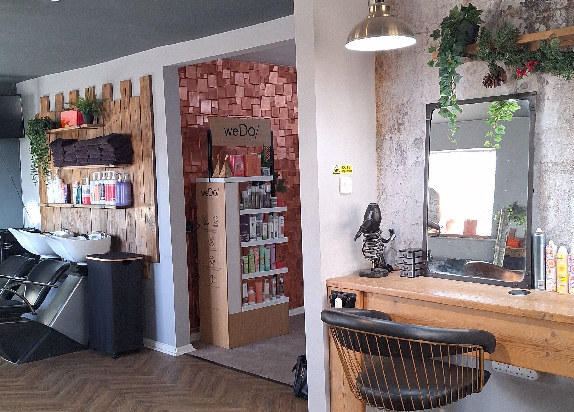 CHEVEUX salon in Beighton, England, GB features a rustic design with modern styling stations and product displays.
