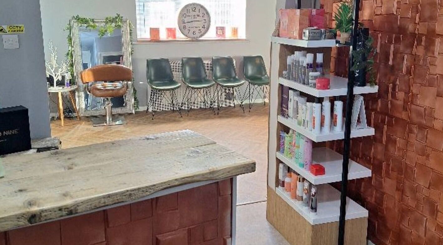 CHEVEUX salon interior in Beighton, England, GB showing a stylish seating area and modern product display.