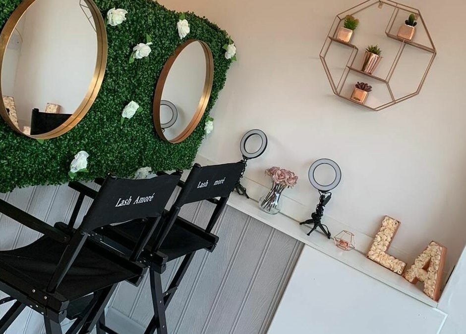 Stylish interior at Lash Amoré Beauty Hub, West Drayton, England with floral decor and beauty chairs.