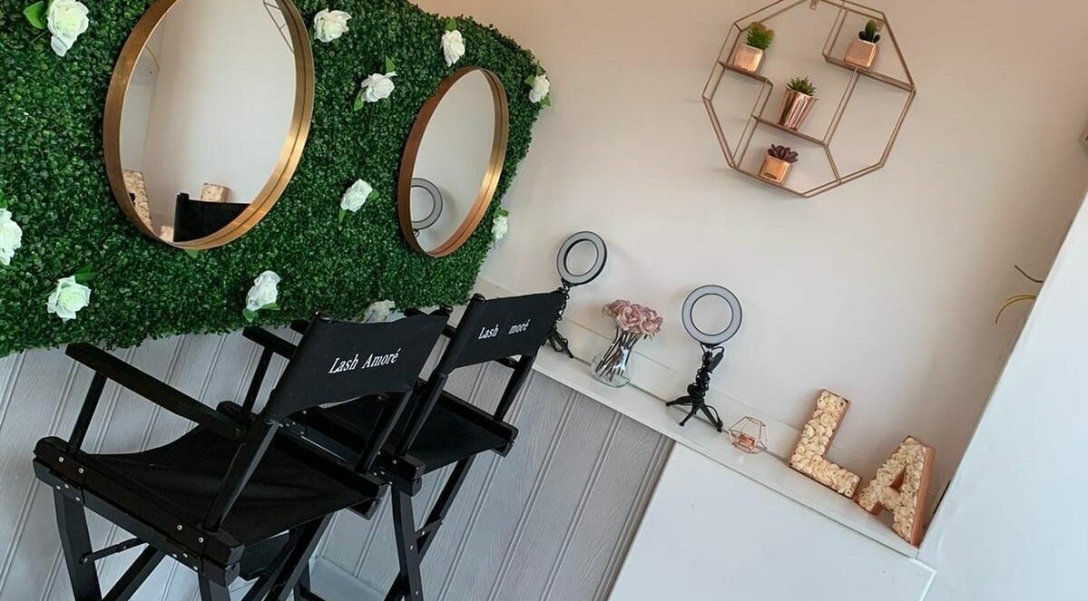 Stylish interior at Lash Amoré Beauty Hub, West Drayton, England with floral decor and beauty chairs.