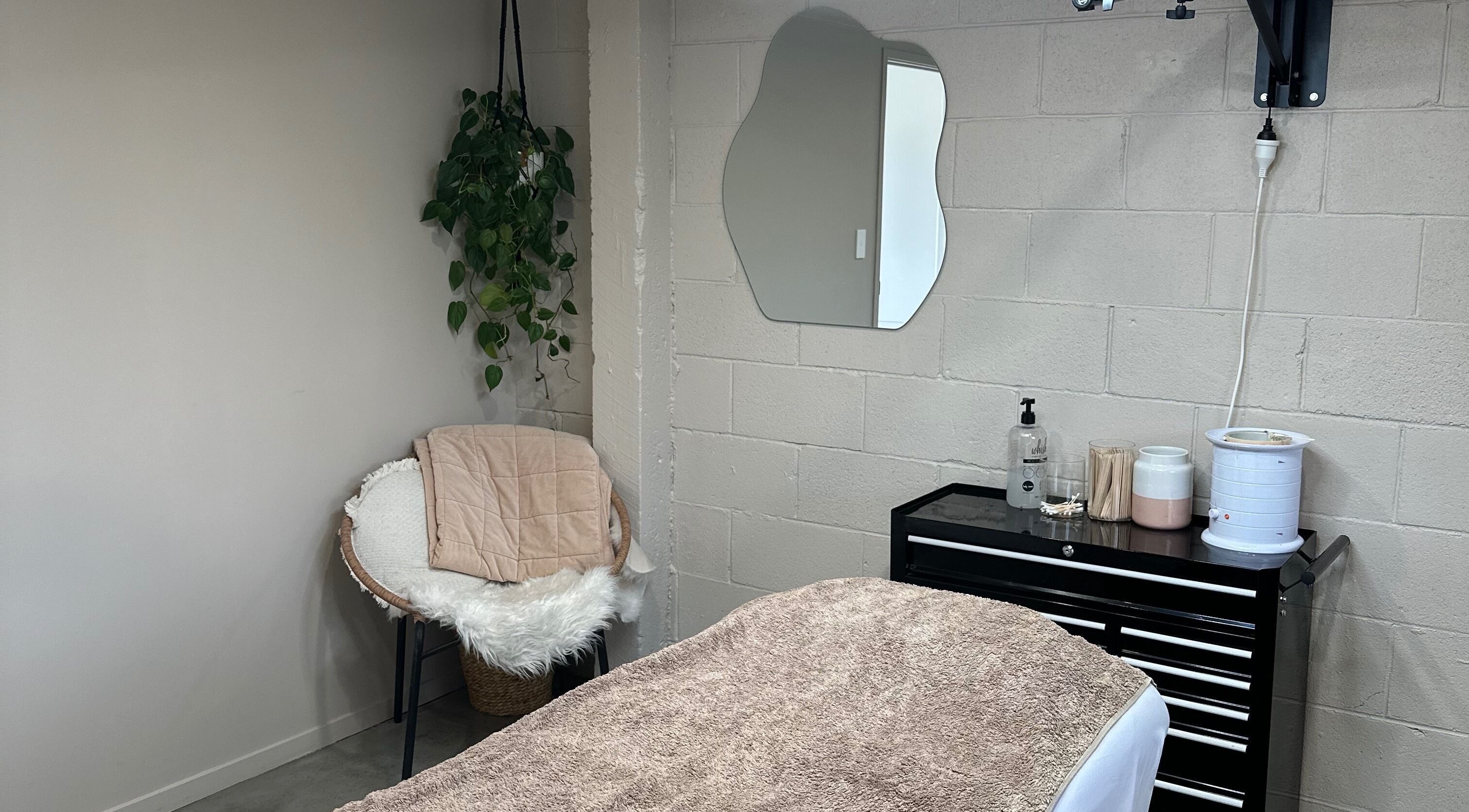 Cozy treatment room at Frankie & me, Kihikihi, Waikato, NZ. Plush chair, chic mirror, inviting and serene atmosphere.