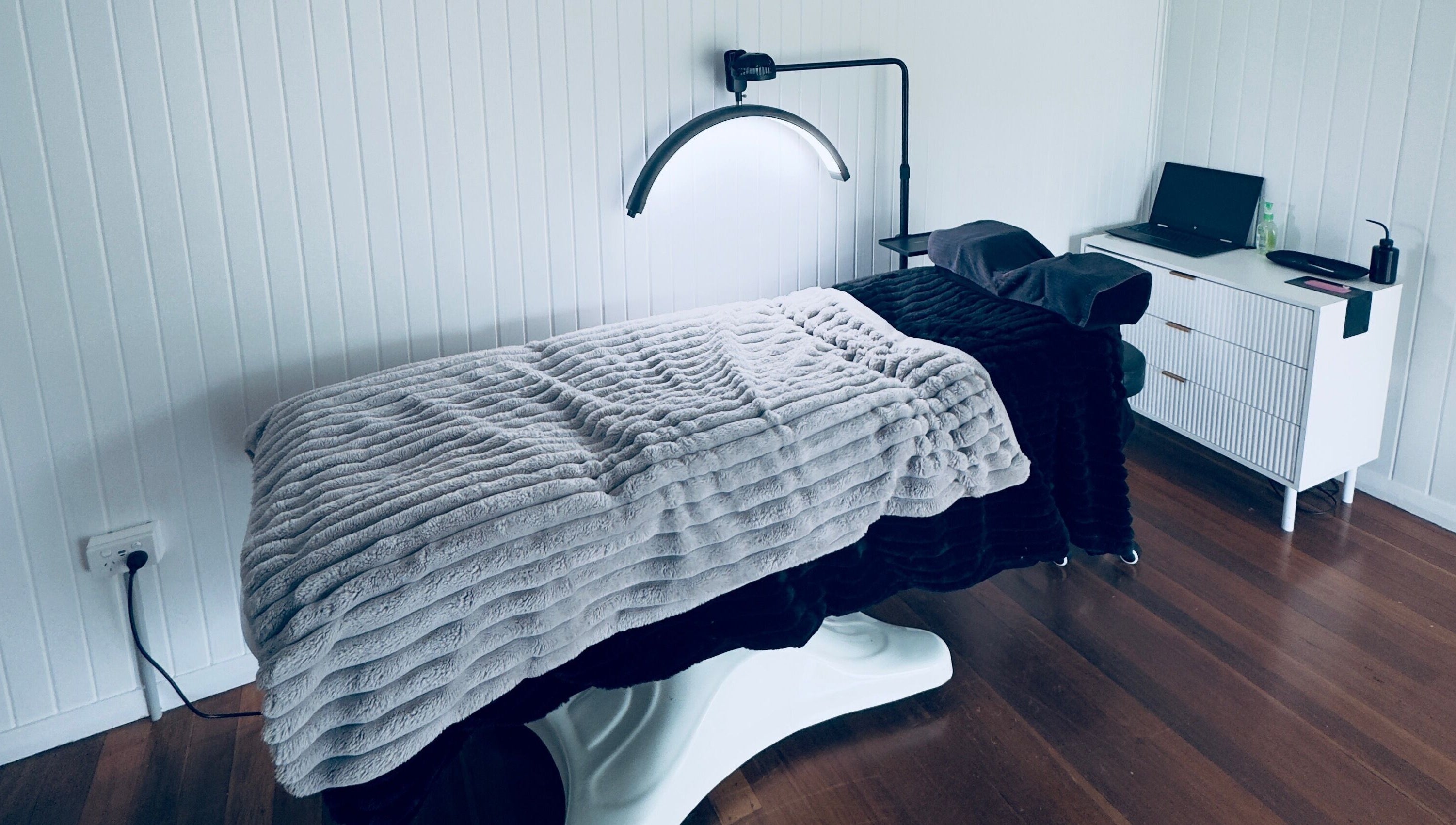 Cozy massage room at Finessed By Cloe in Berserker, Queensland, AU with warm-toned decor and soothing ambiance.