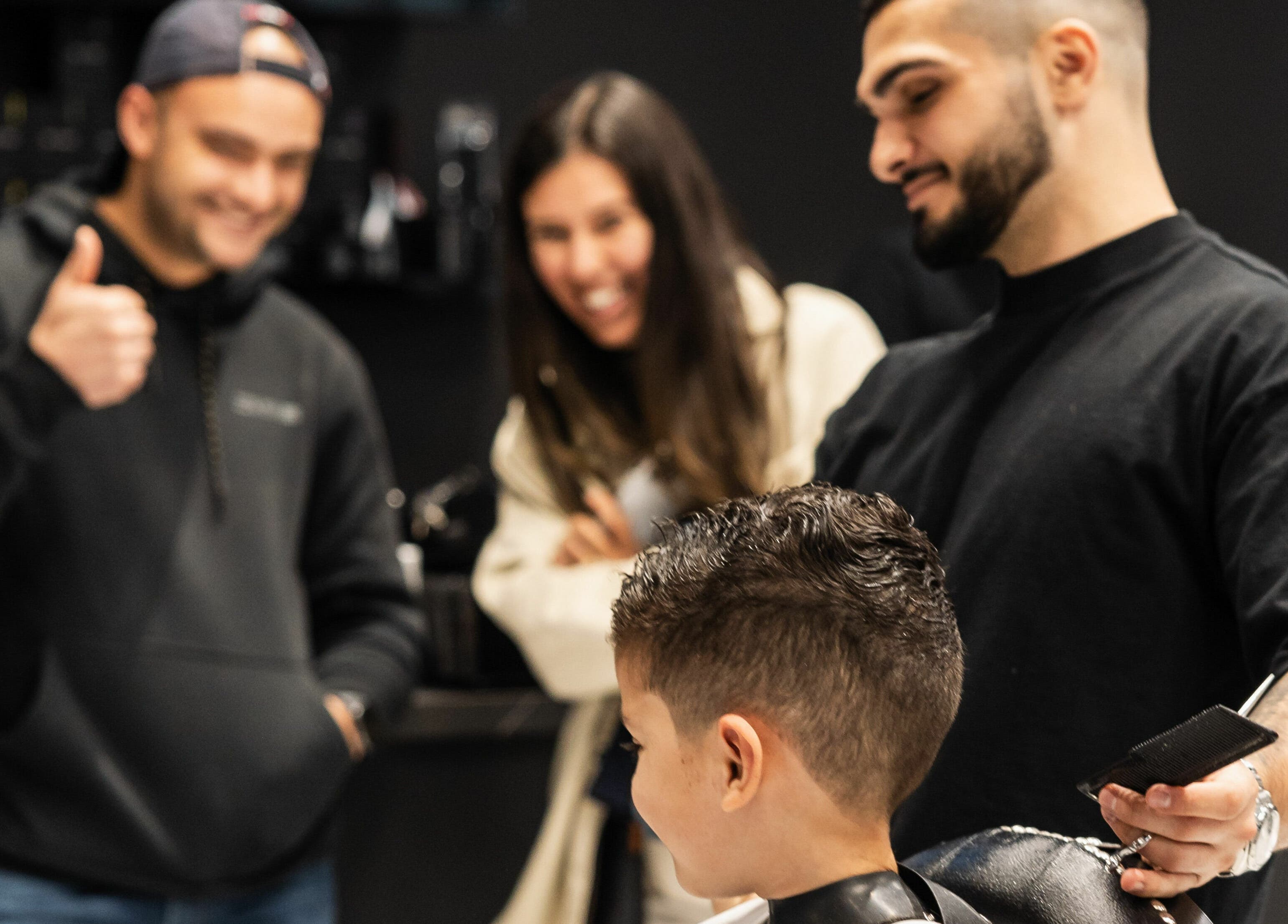 Barber at ACE OF FADEZ LANE COVE in Lane Cove, New South Wales, AU giving a child a stylish haircut.