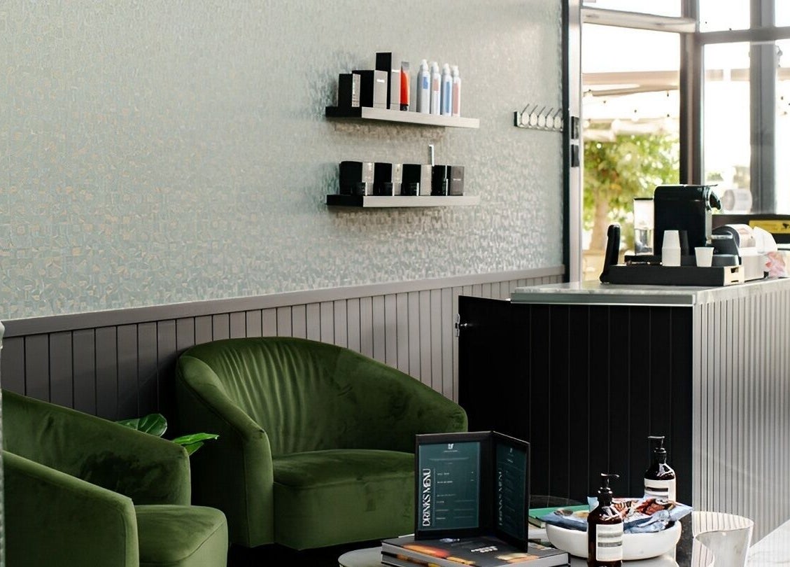 Stylish lounge area at ACE OF FADEZ CROWS NEST, Crows Nest, New South Wales, AU, with green chairs and products.