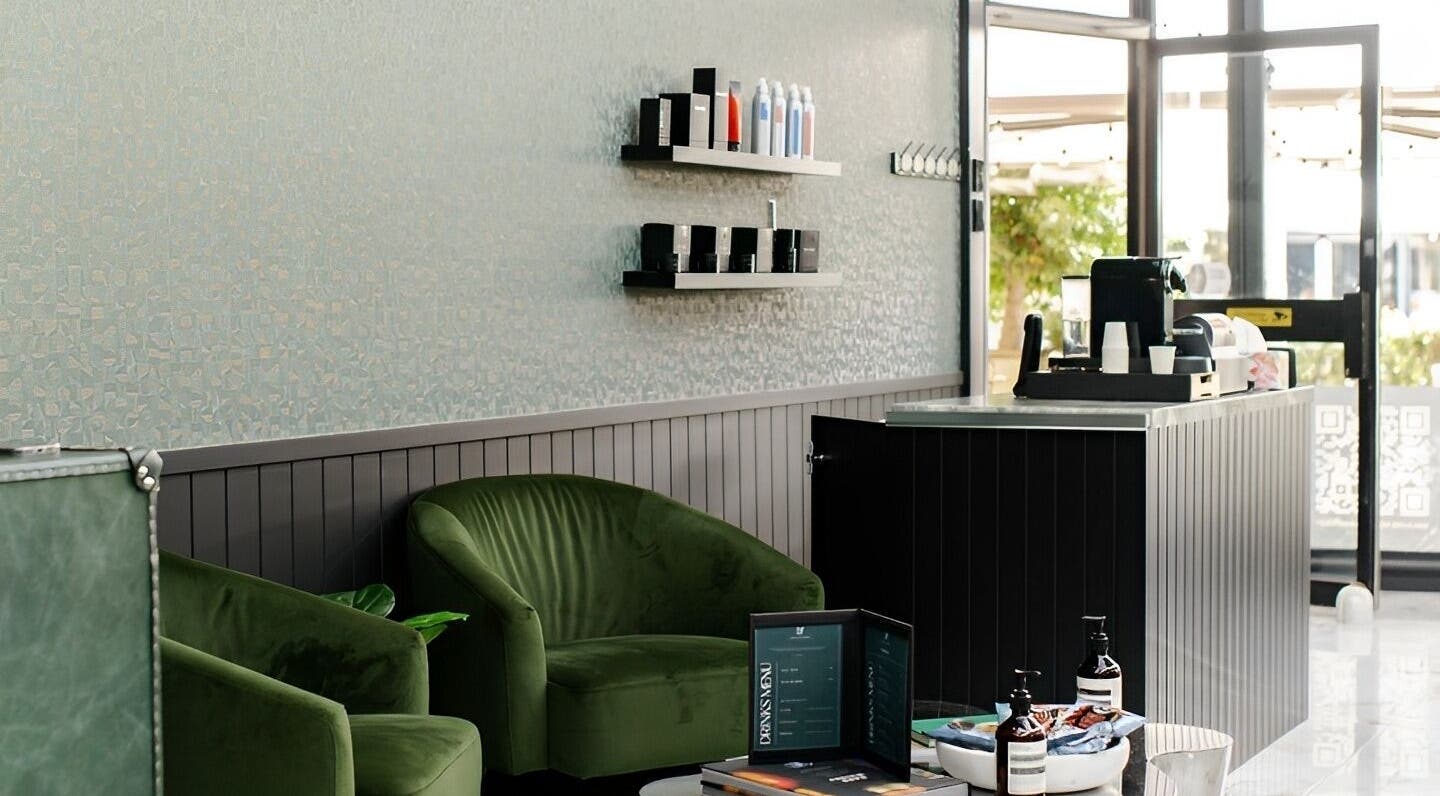 Stylish lounge area at ACE OF FADEZ CROWS NEST, Crows Nest, New South Wales, AU, with green chairs and products.