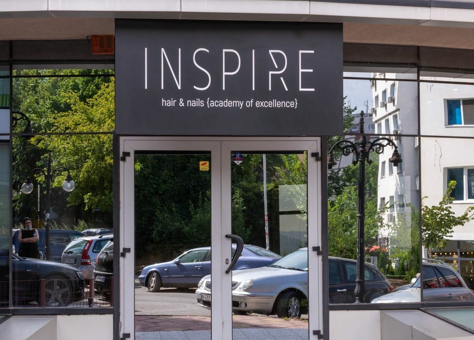 Entrance of Salon Inspire, kv. Studentski Grad, София, BG, showcasing modern glass exterior design.