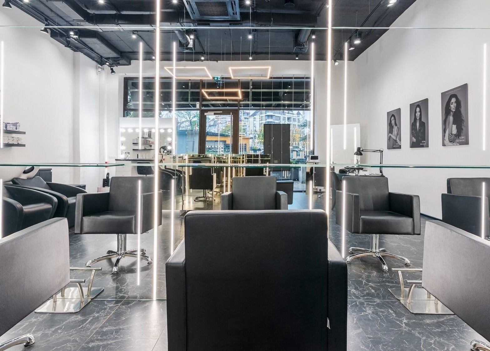 Sophisticated salon interior at Salon Inspire kv. Hladilnika Paradise Mall, София, BG, featuring sleek black chairs.