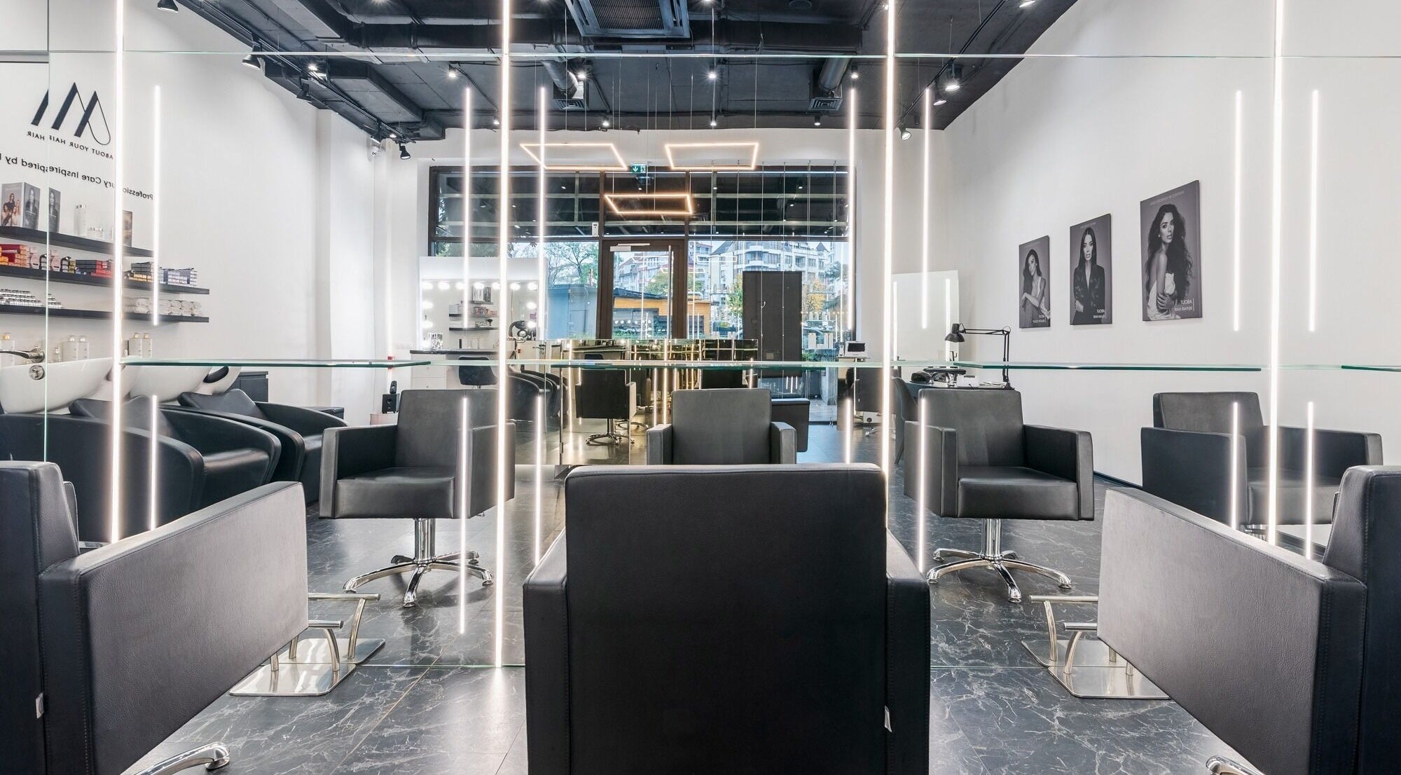Sophisticated salon interior at Salon Inspire kv. Hladilnika Paradise Mall, София, BG, featuring sleek black chairs.