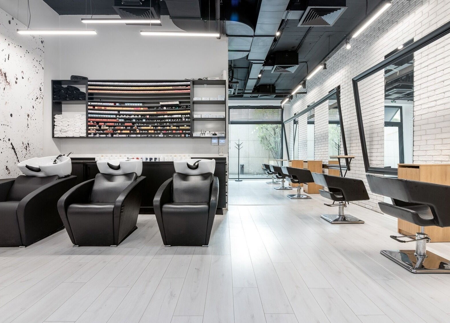Modern interior of Salon Inspire, kv. Mladost 1, София, BG with sleek black chairs and spacious mirrors.