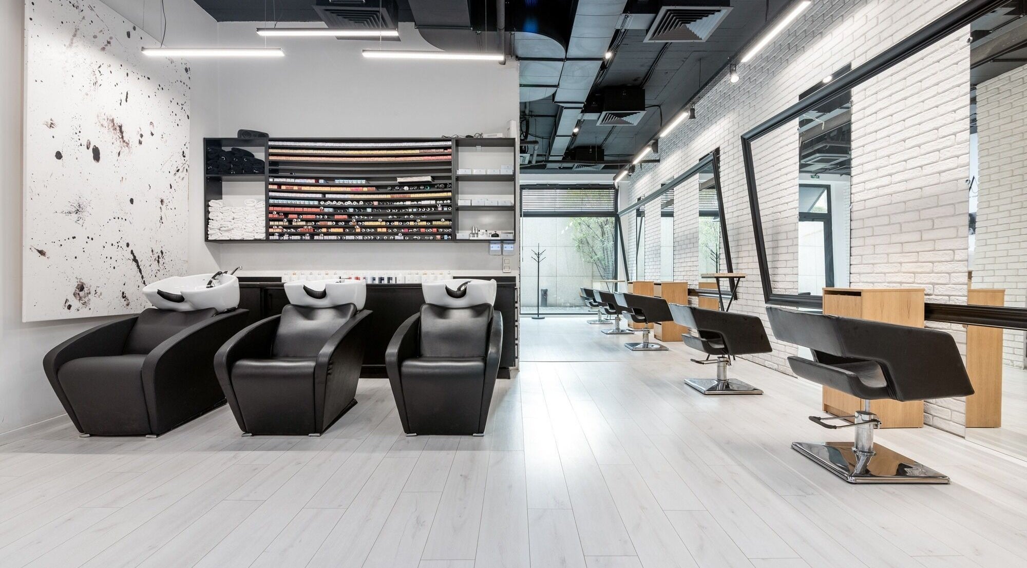 Modern interior of Salon Inspire, kv. Mladost 1, София, BG with sleek black chairs and spacious mirrors.