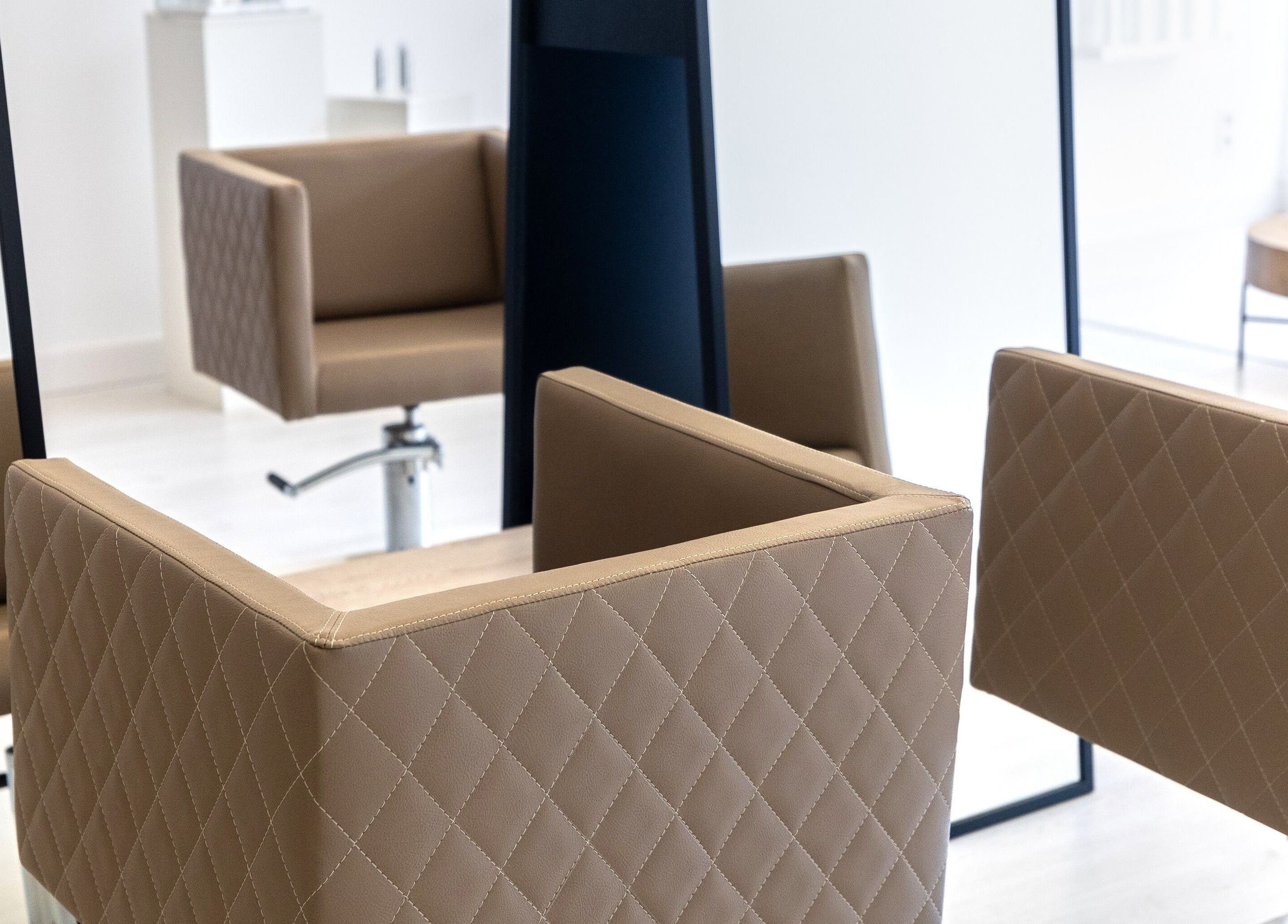 Modern salon chairs at Salon Inspire, kv. Iztok, София, BG, showcasing a stylish and professional ambiance.