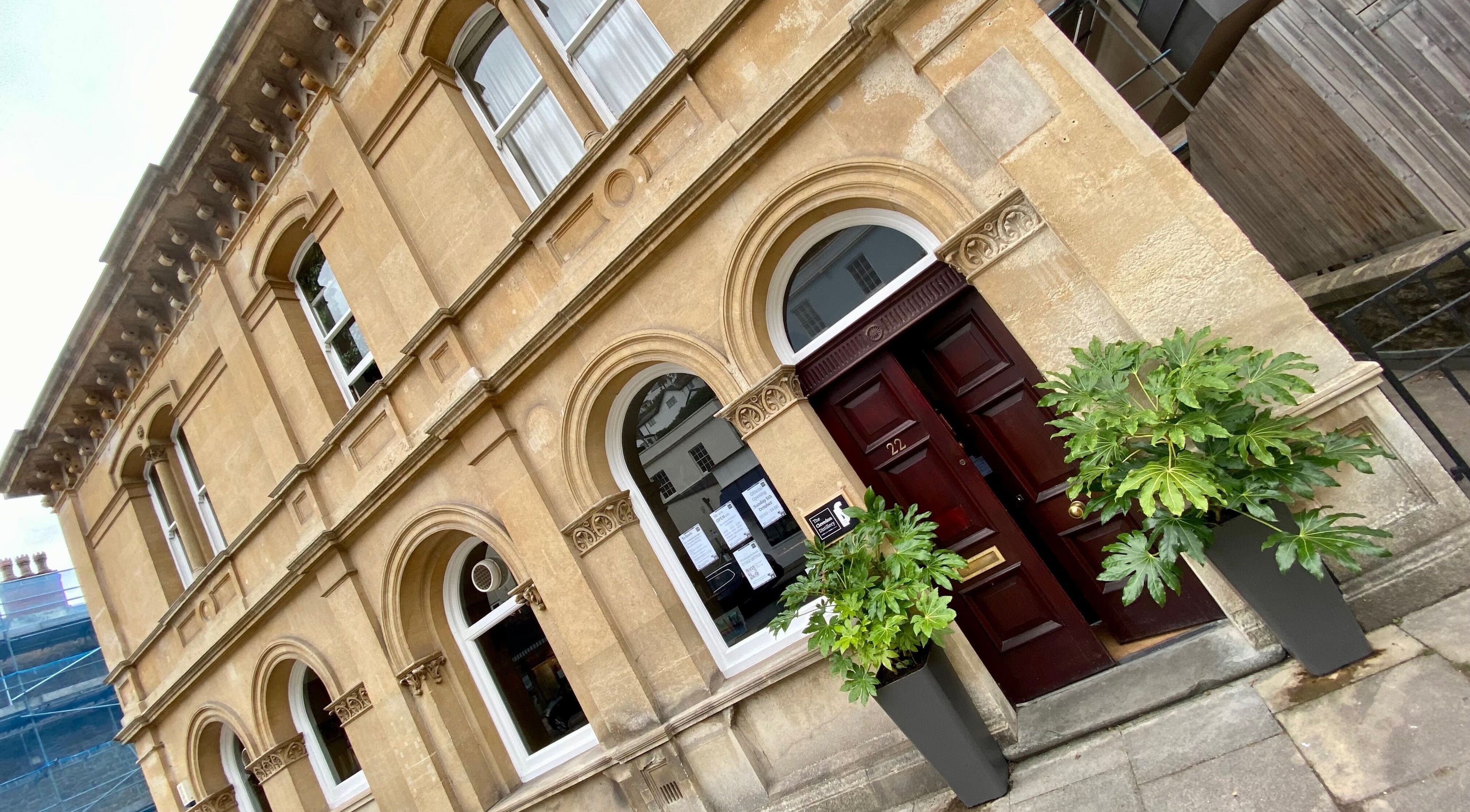 Classical facade of Lukasz Szejka Studio in Clevedon, England, GB, featuring arched windows and greenery.