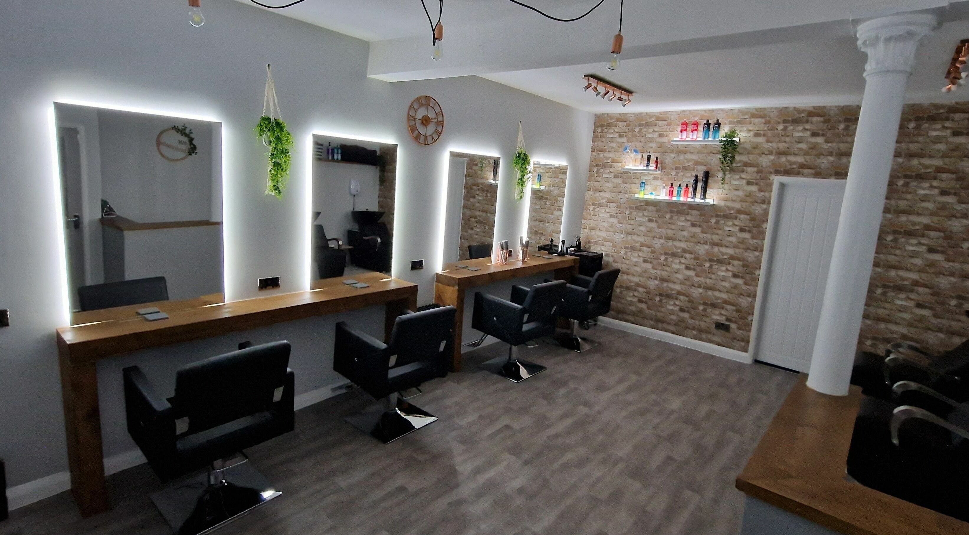Modern salon interior at Poise Hairdressing, Grassmoor, England, GB with elegant styling stations and decor.