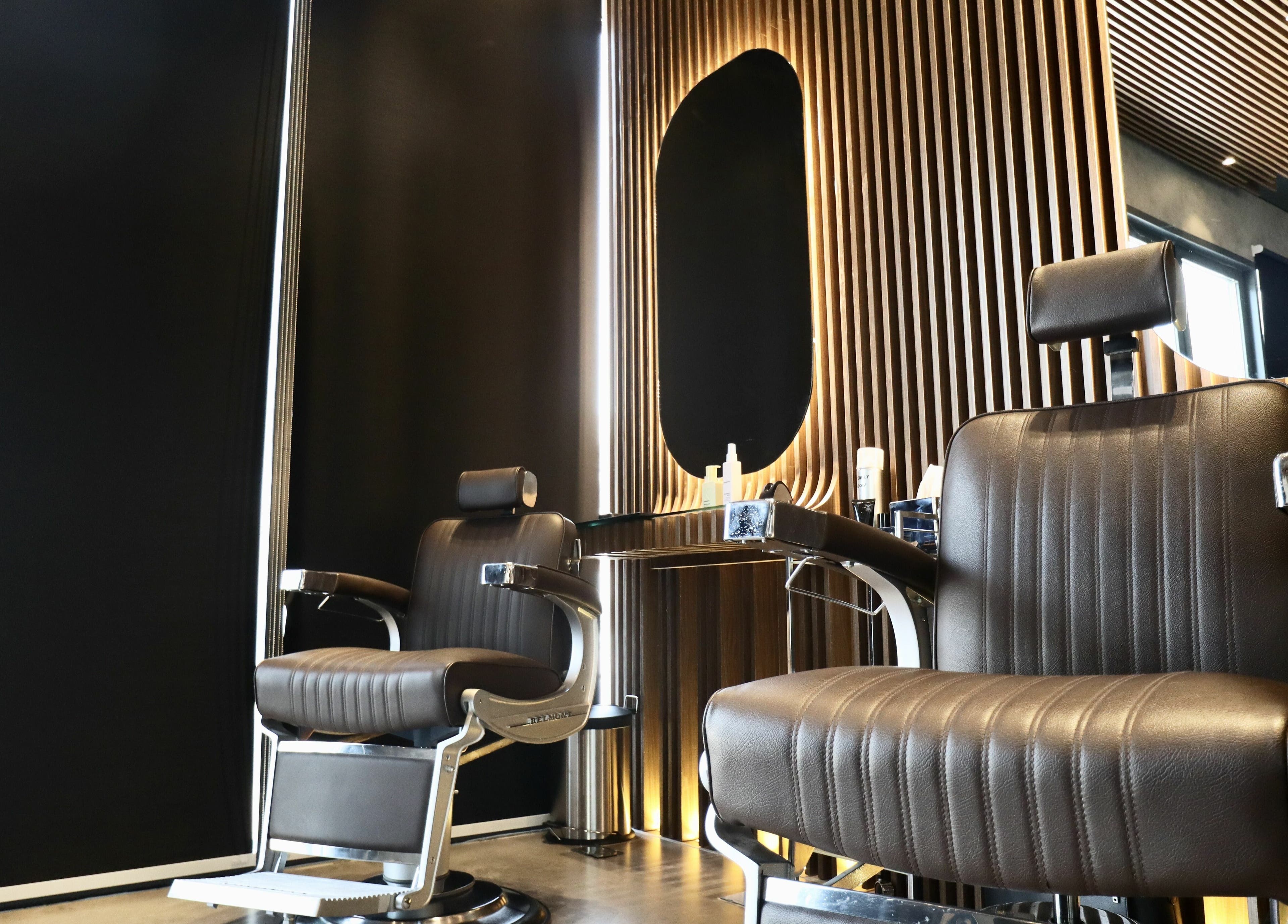 Stylish barber chairs at House of Fade, Dubai, AE showcasing modern design and comfort.