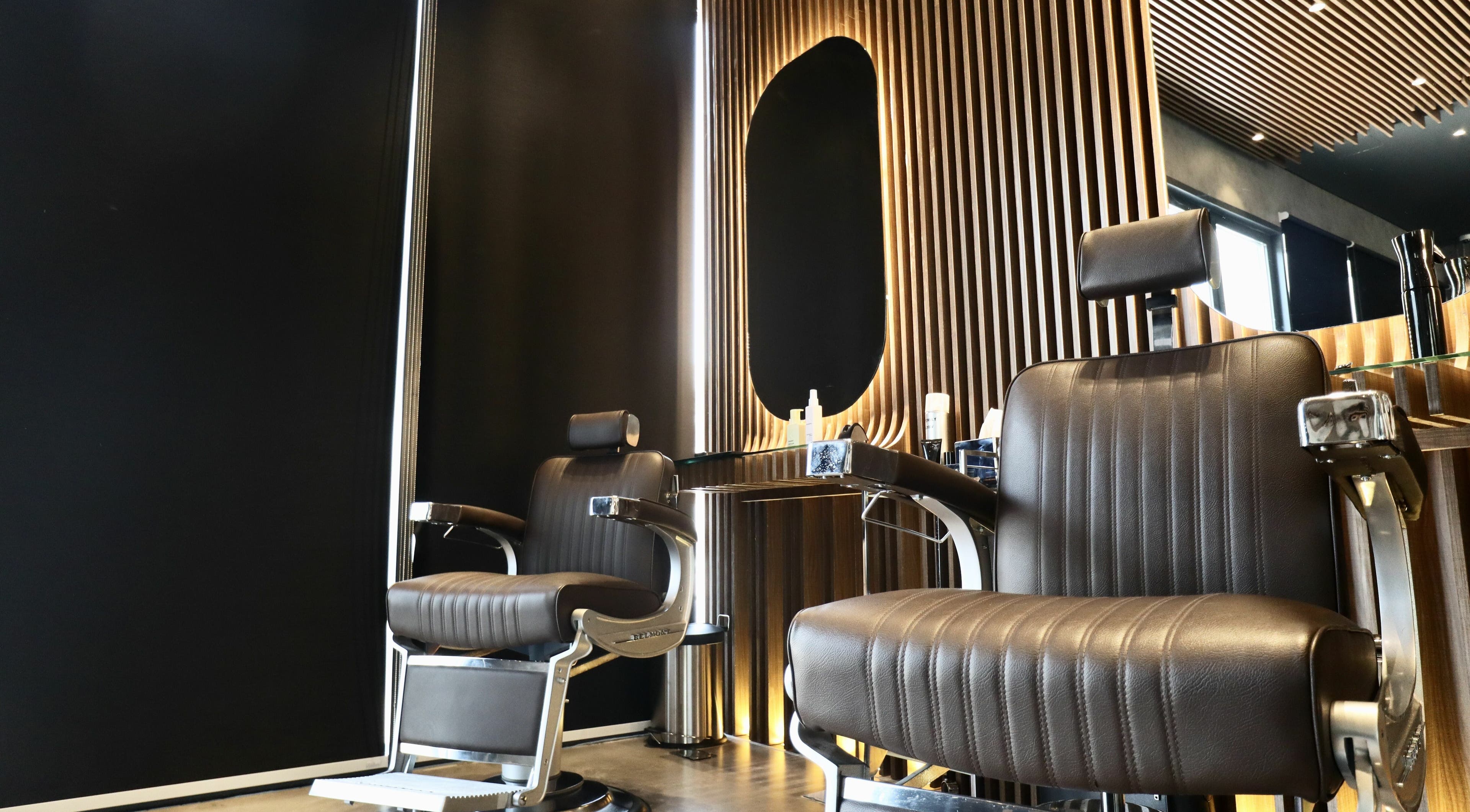Stylish barber chairs at House of Fade, Dubai, AE showcasing modern design and comfort.