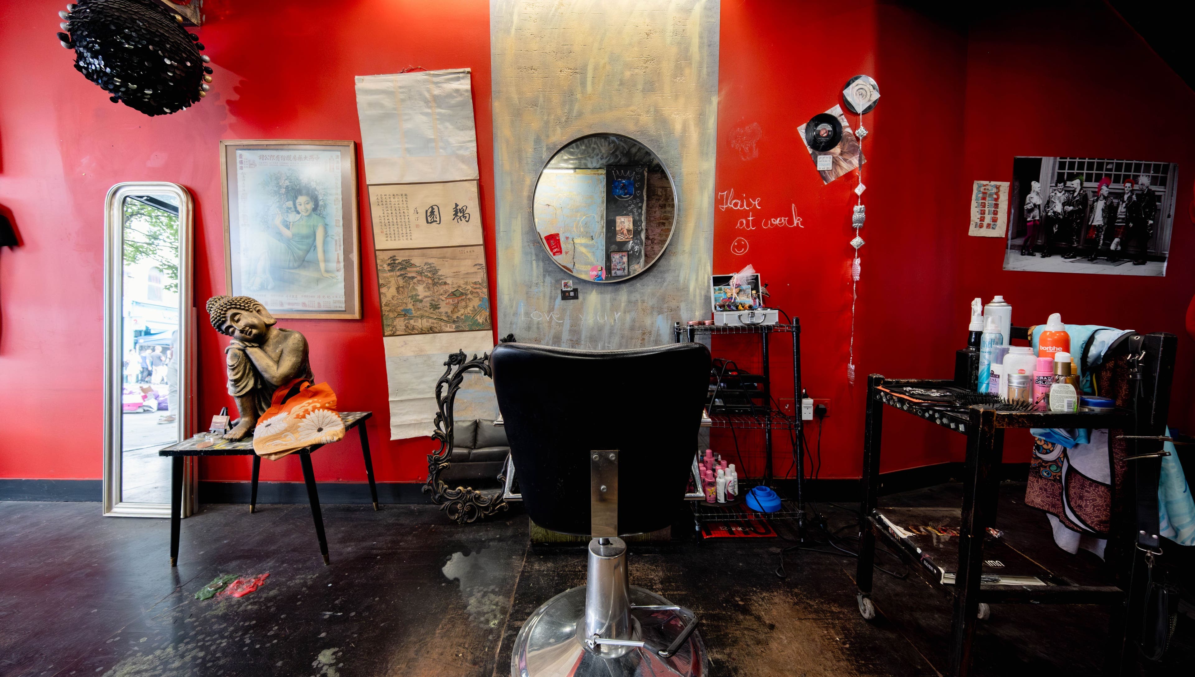 Eclectic salon interior with vibrant red walls at Unparalleled 145, London, England, GB, offering a unique ambiance.