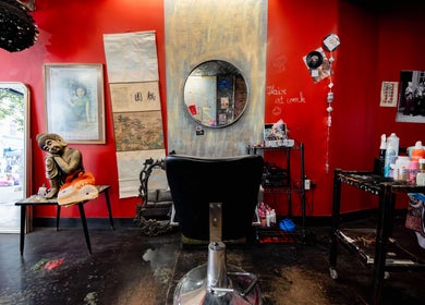 Eclectic salon interior with vibrant red walls at Unparalleled 145, London, England, GB, offering a unique ambiance.