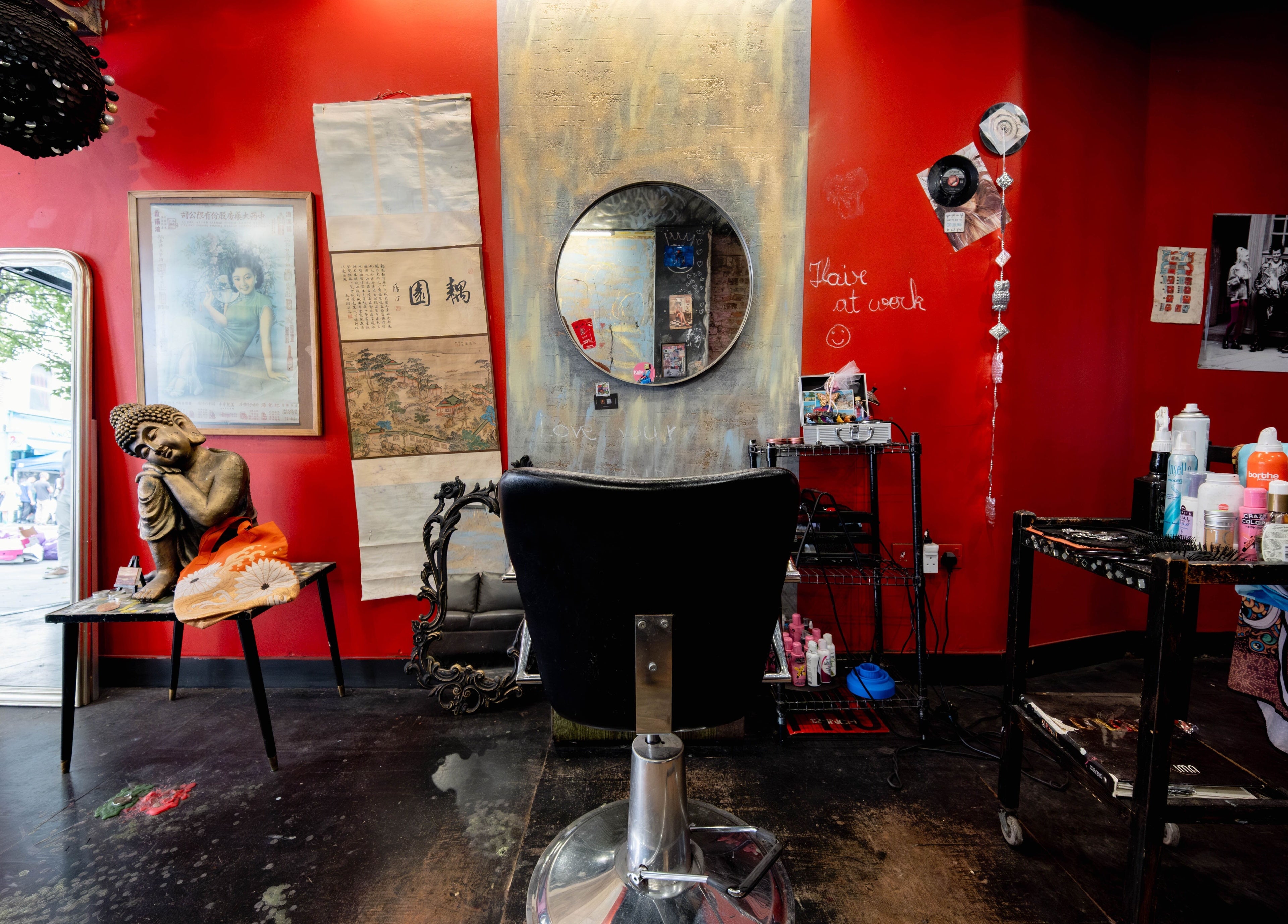 Eclectic salon interior with vibrant red walls at Unparalleled 145, London, England, GB, offering a unique ambiance.