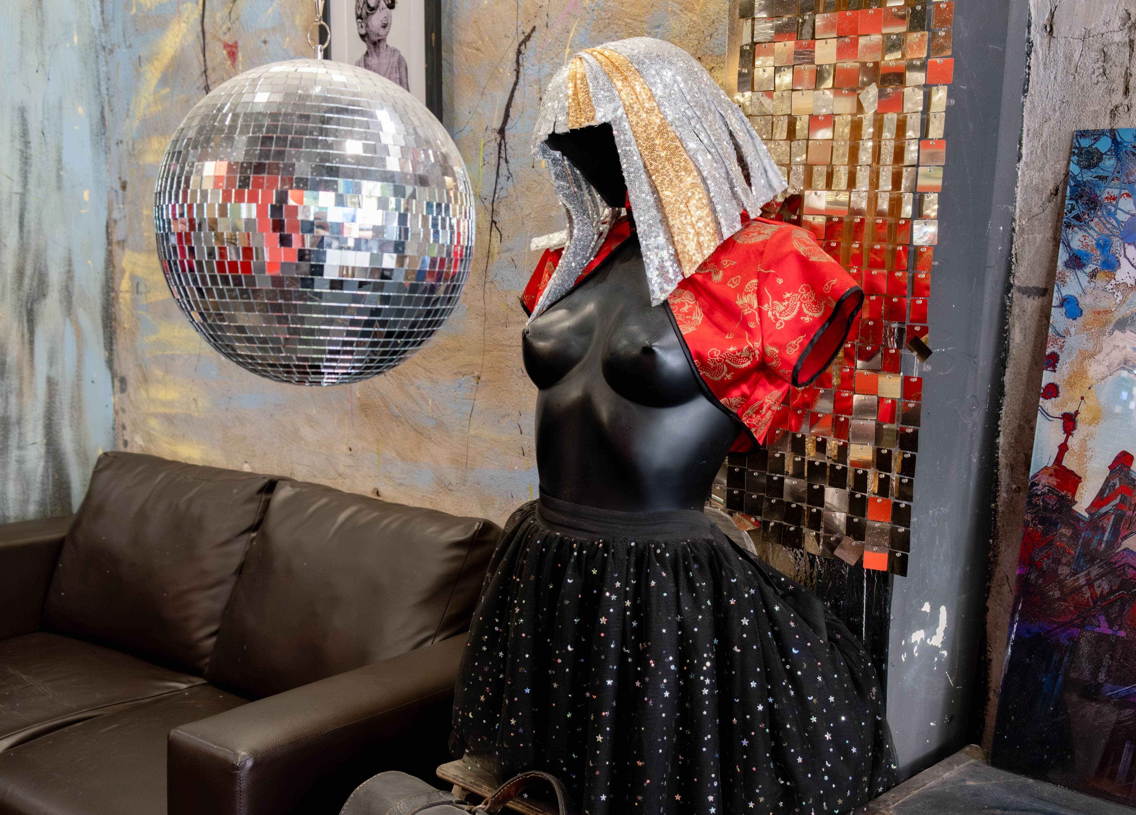 Artful disco-themed decor at Unparalleled 145, London, England, GB with mannequin and shimmering sphere.