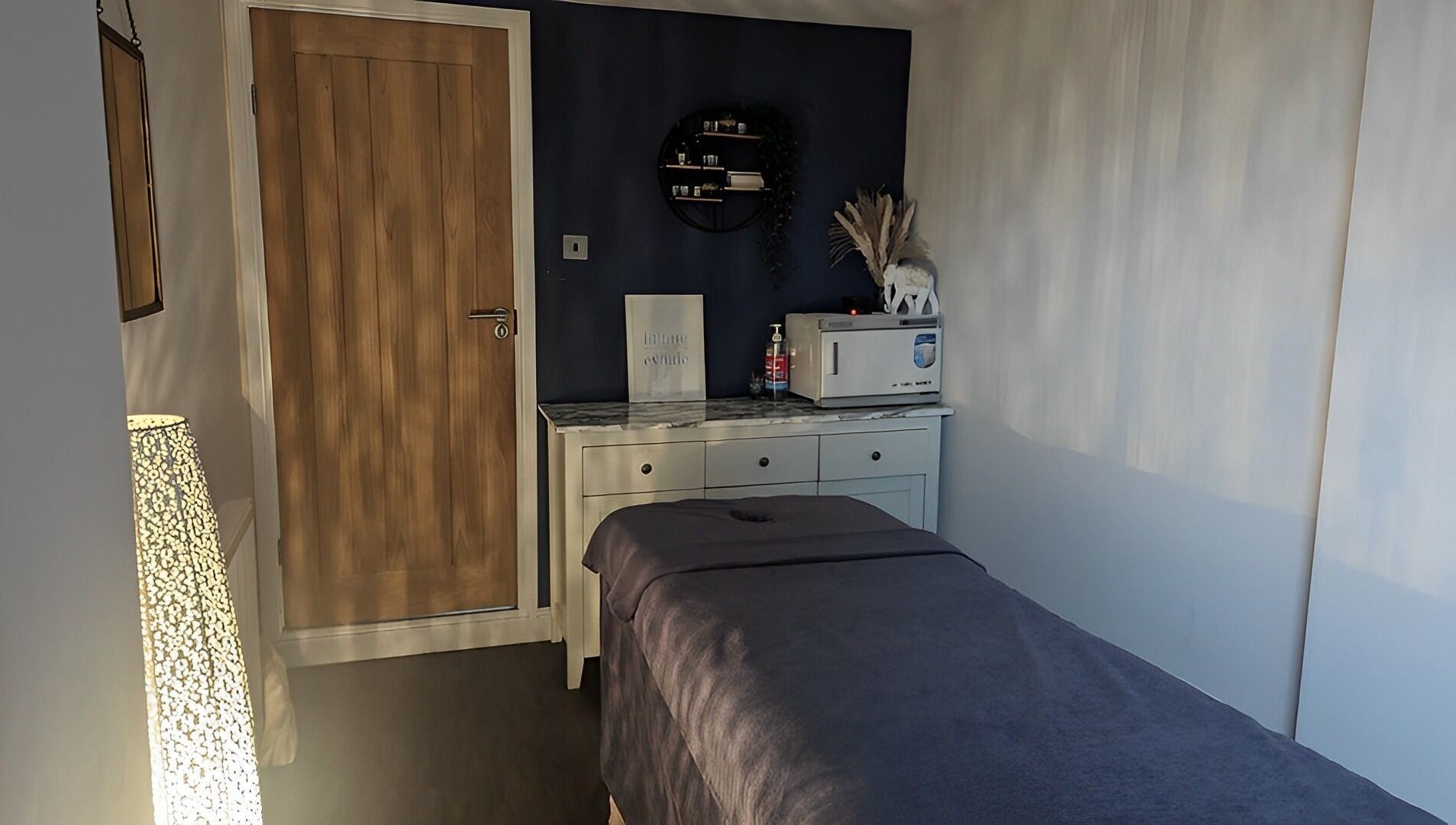 Calming treatment room at Sensational Beauty, Mirfield, England, GB, featuring a massage table and soft lighting.
