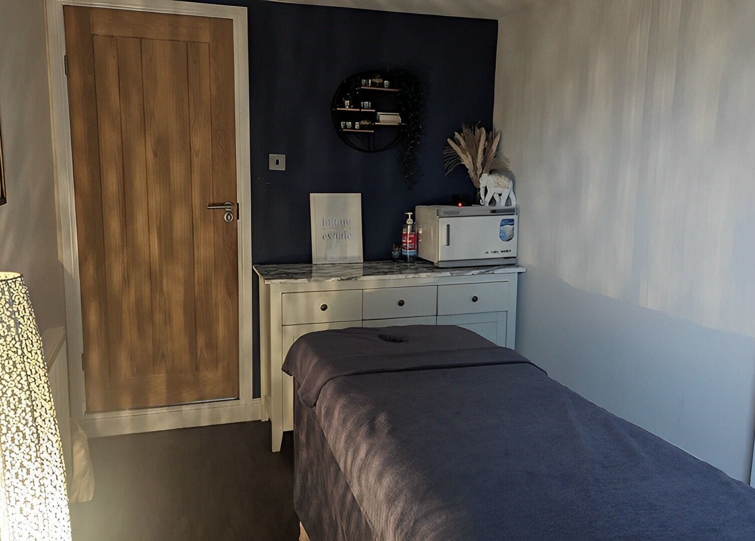 Calming treatment room at Sensational Beauty, Mirfield, England, GB, featuring a massage table and soft lighting.