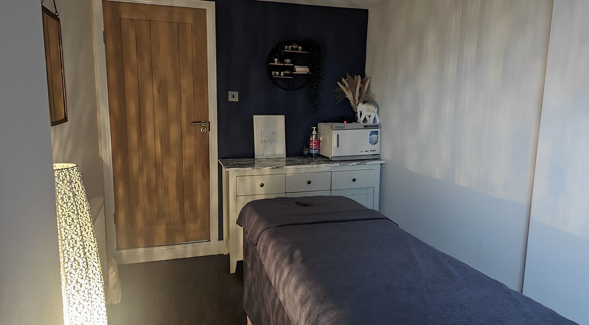 Calming treatment room at Sensational Beauty, Mirfield, England, GB, featuring a massage table and soft lighting.