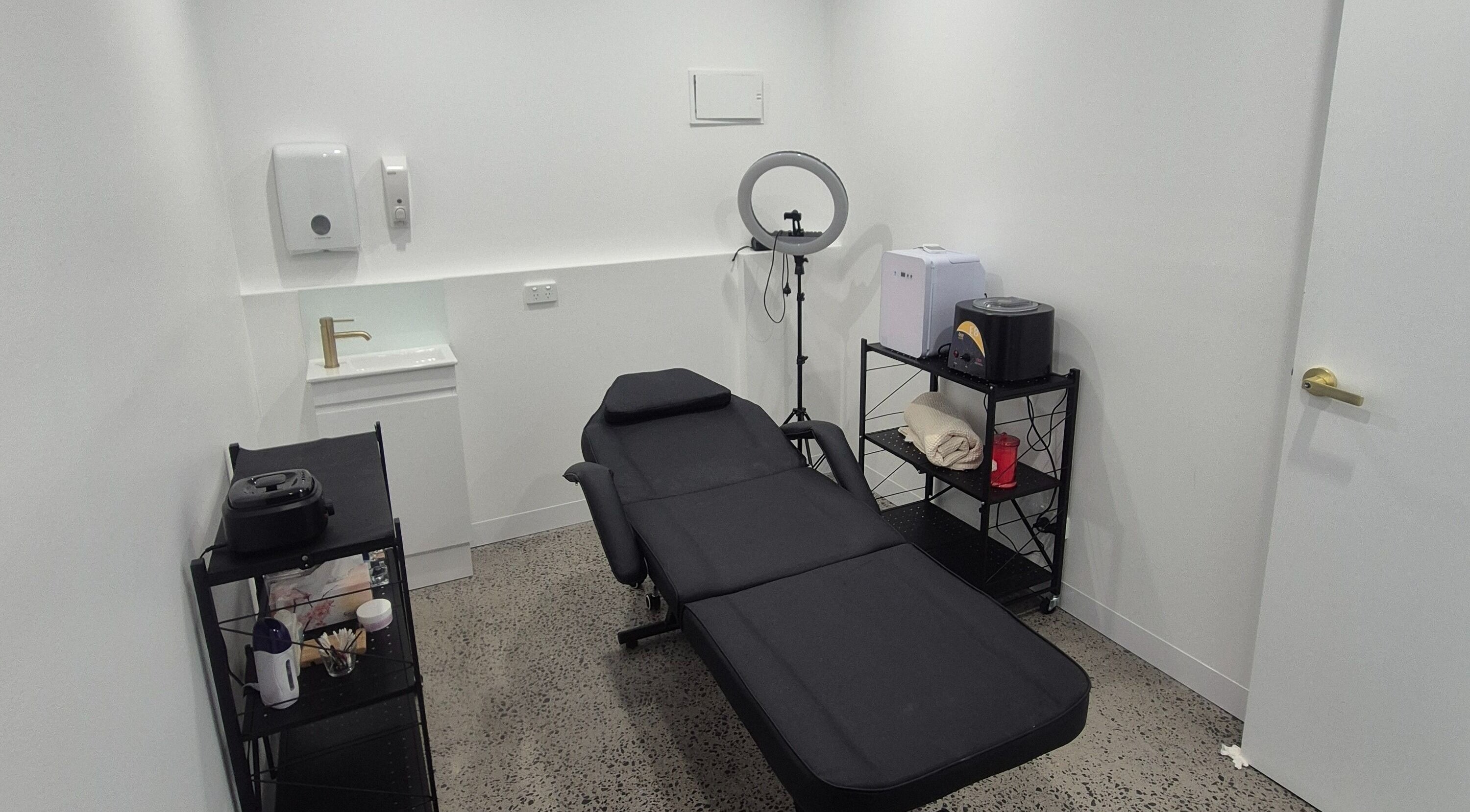 Relaxing treatment room at The Beautyque, Rockdale, New South Wales, AU with sleek furnishings.