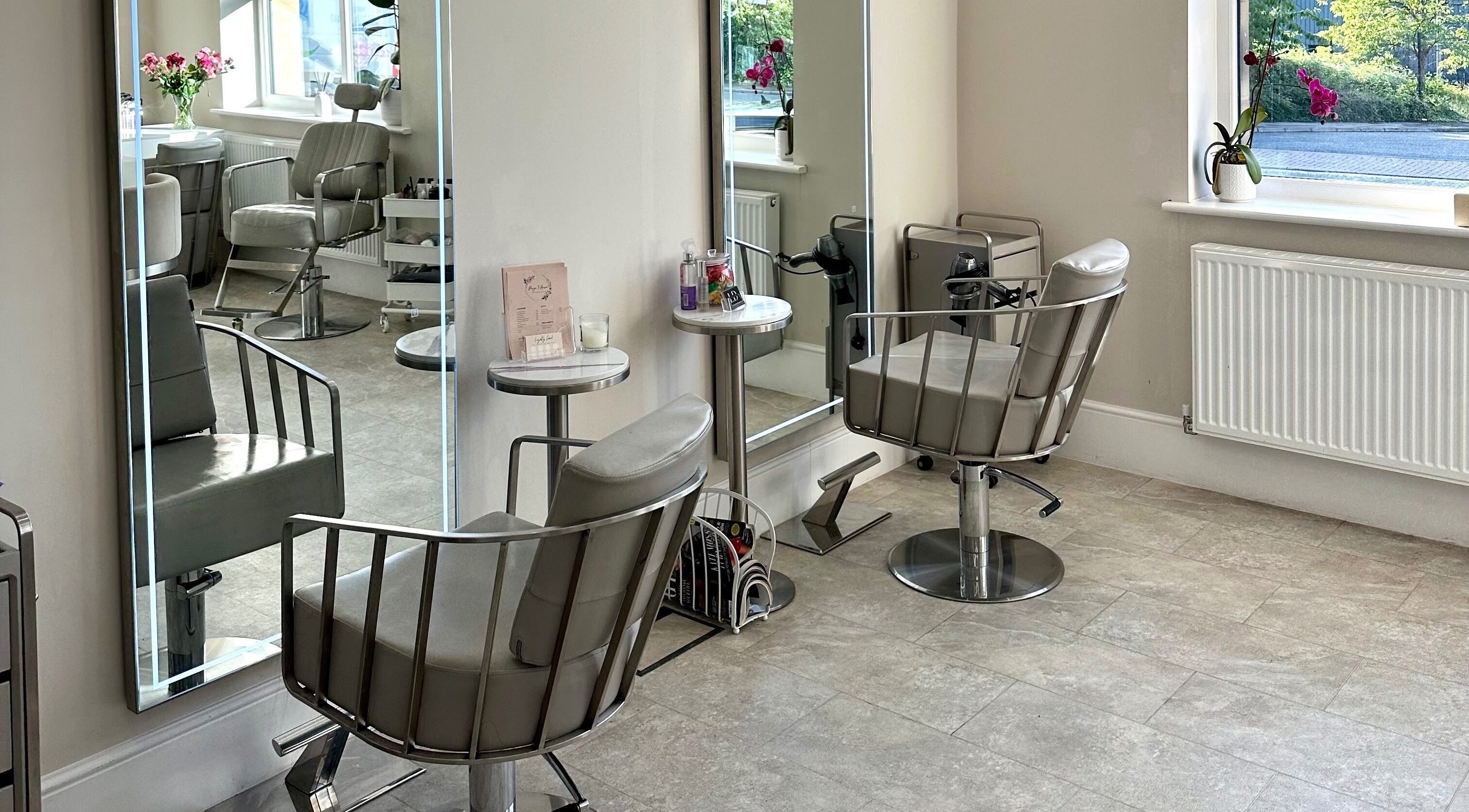 Elegant salon interior at Lashtoxx in Halifax, England with stylish chairs and mirrors.