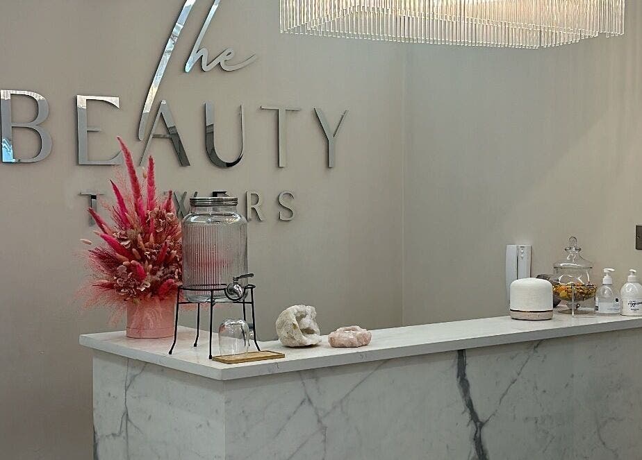 Lashtoxx reception area in Halifax, England, GB with chic decor and floral arrangement.