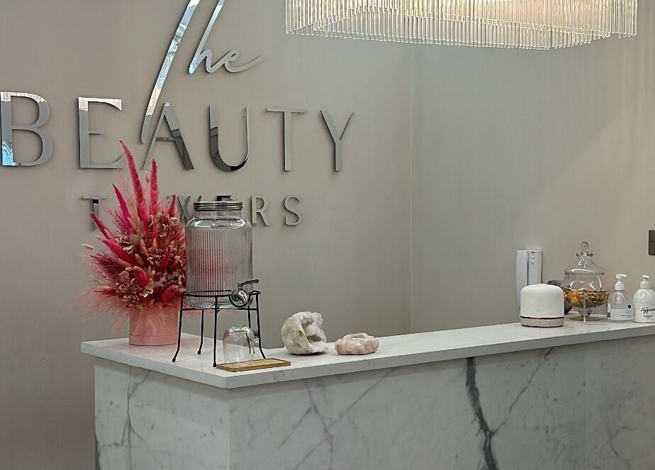 Lashtoxx reception area in Halifax, England, GB with chic decor and floral arrangement.