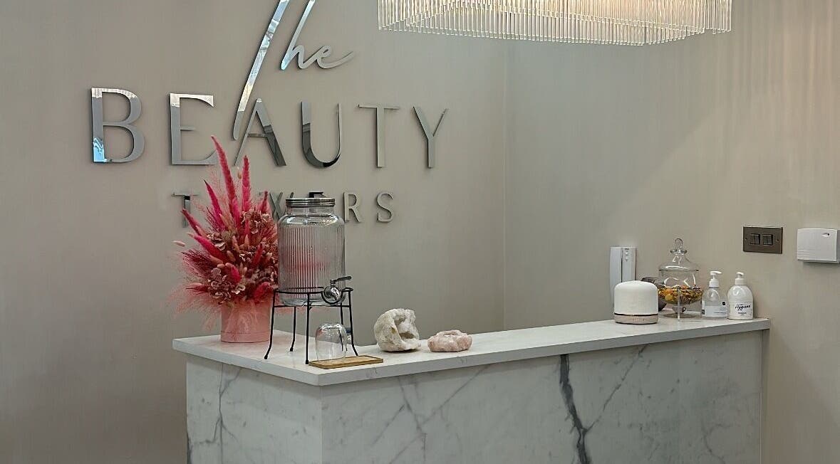 Lashtoxx reception area in Halifax, England, GB with chic decor and floral arrangement.