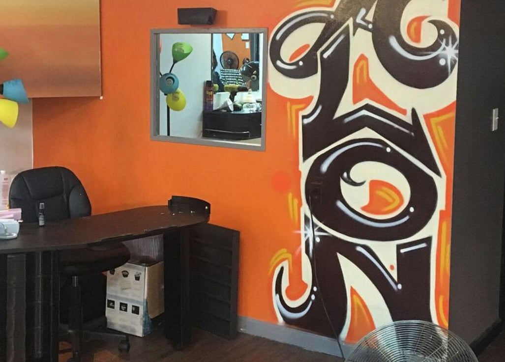 Reception area at Perfect Blendz Barber Lounge, Jonesboro, Georgia, US, featuring colorful decor and a desk.