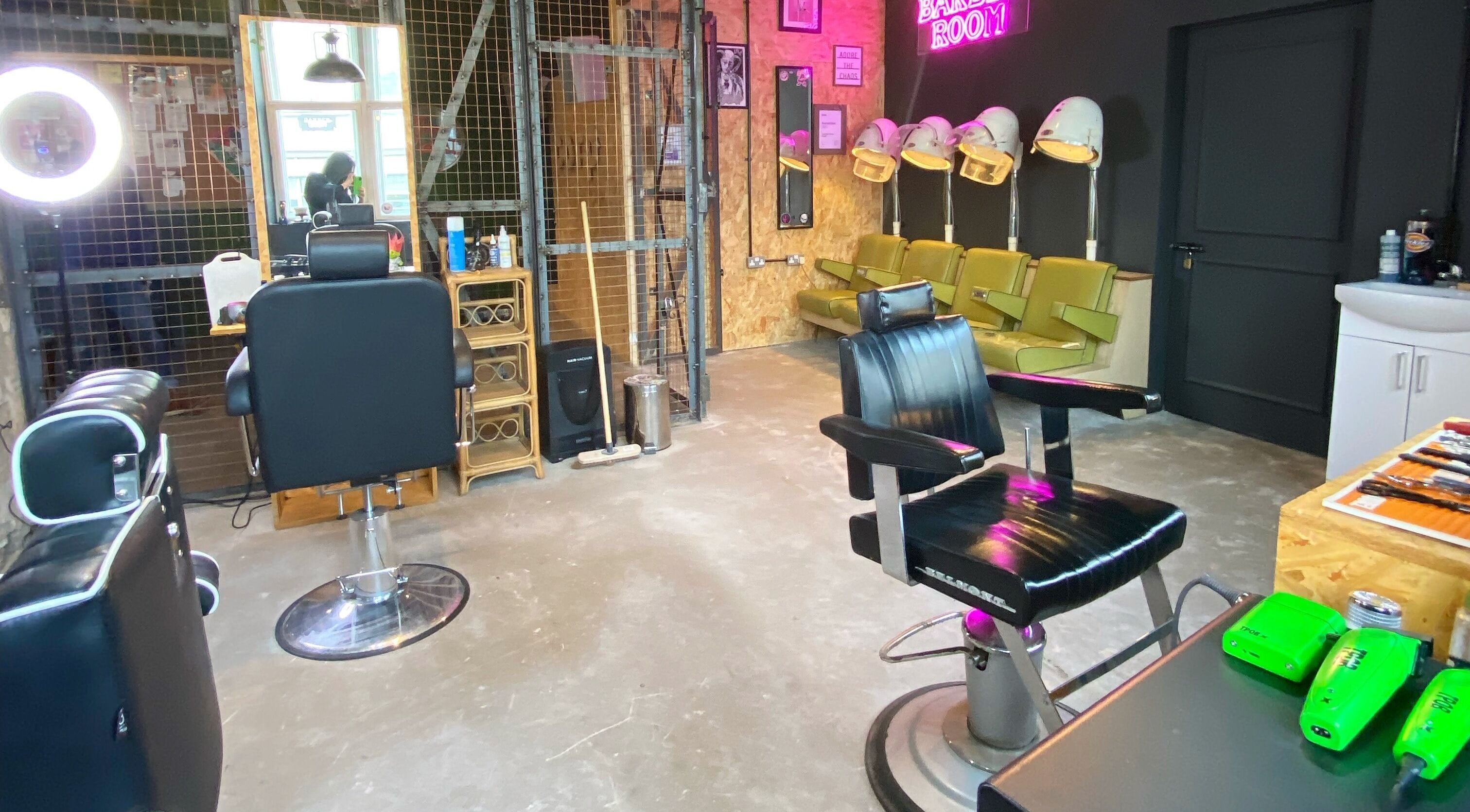 Modern barber station inside The Barber Room Cardiff, Cardiff, Wales, GB, featuring stylish chairs and equipment.