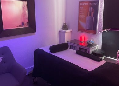 Serene spa room at Vanity Case, Crewe, England, GB, with calming lighting and a comfortable massage table.