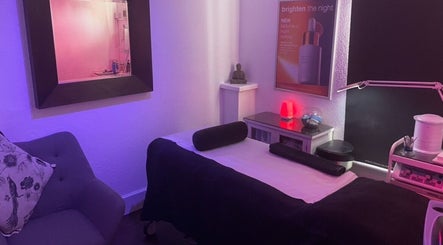 Serene spa room at Vanity Case, Crewe, England, GB, with calming lighting and a comfortable massage table.