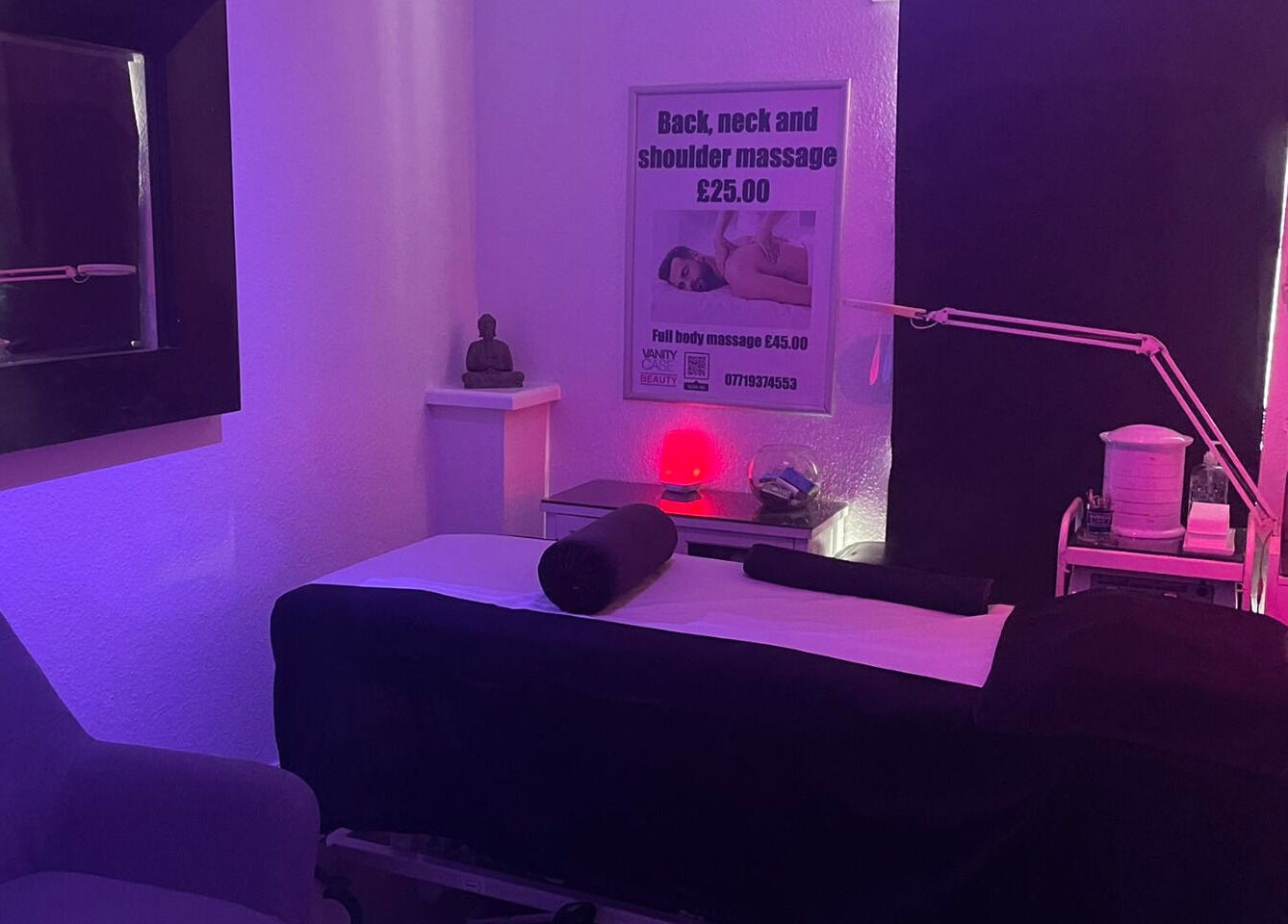 Relaxing massage room at Vanity Case in Crewe, England, GB with serene lighting and cozy setup.