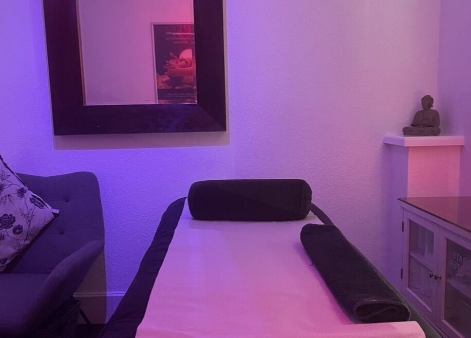 Relaxing treatment room at Vanity Case in Crewe, England, GB with ambient lighting and cozy decor.