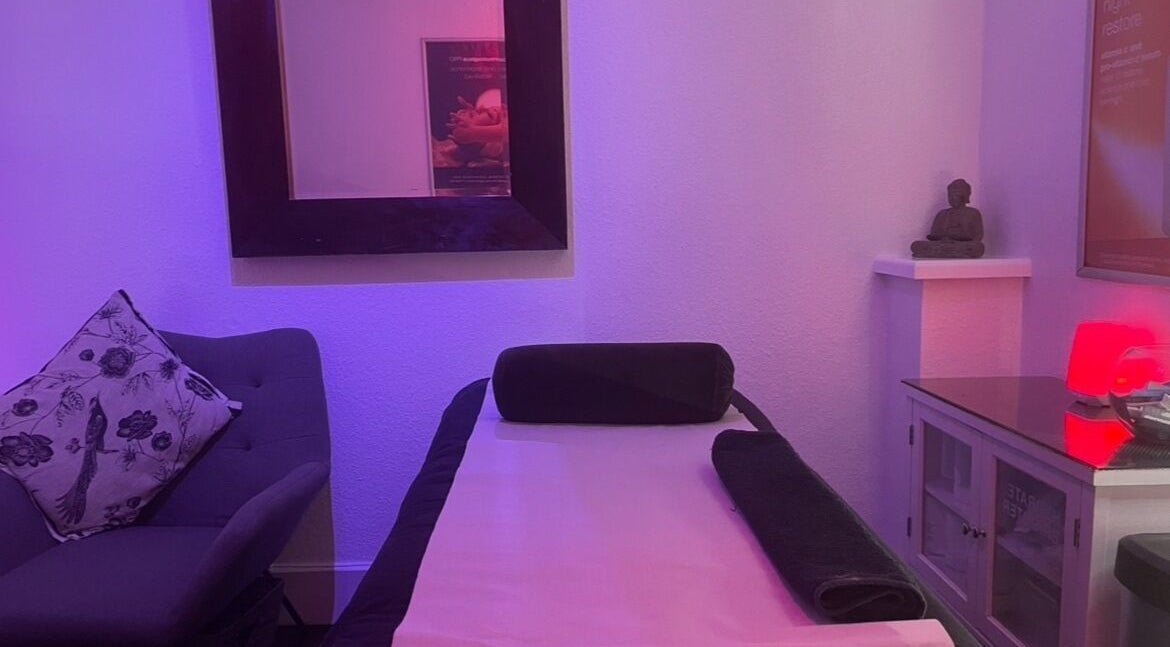 Relaxing treatment room at Vanity Case in Crewe, England, GB with ambient lighting and cozy decor.