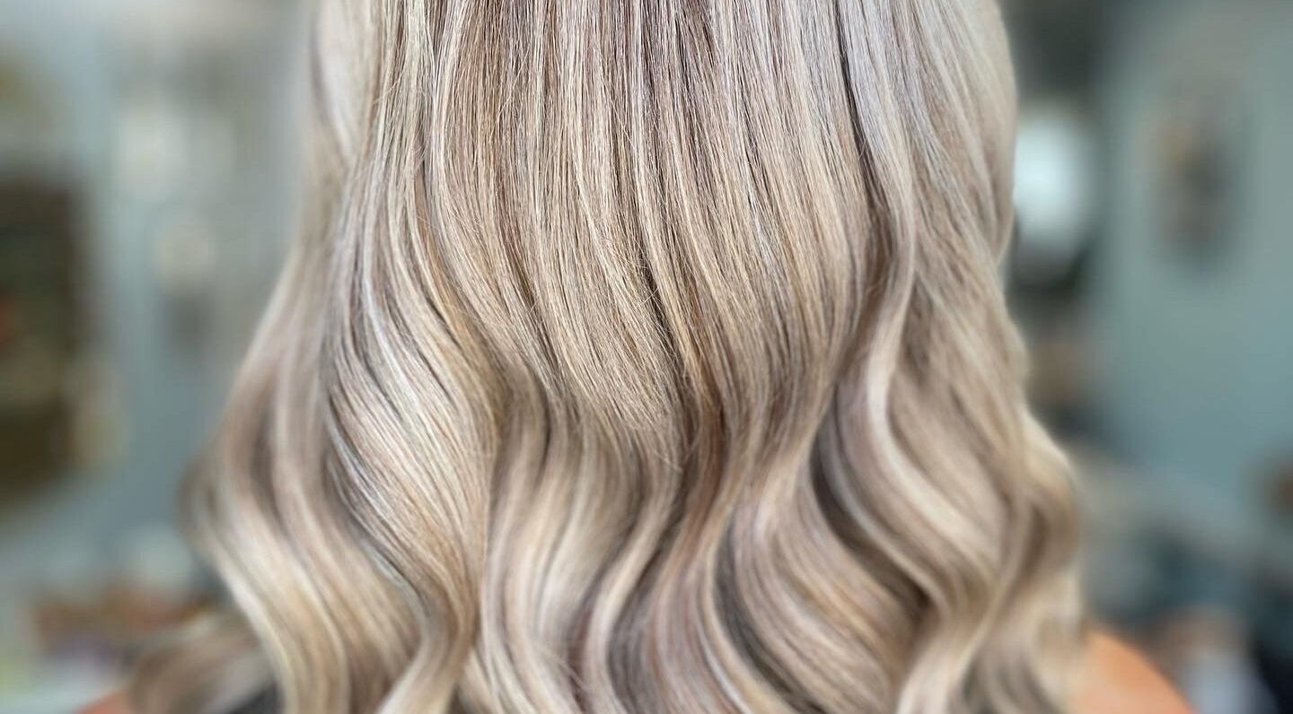 Beautiful wavy blonde hair styled at Elysian Hair - Looe, Cornwall. Visit us in Looe, England, GB for perfect hair.
