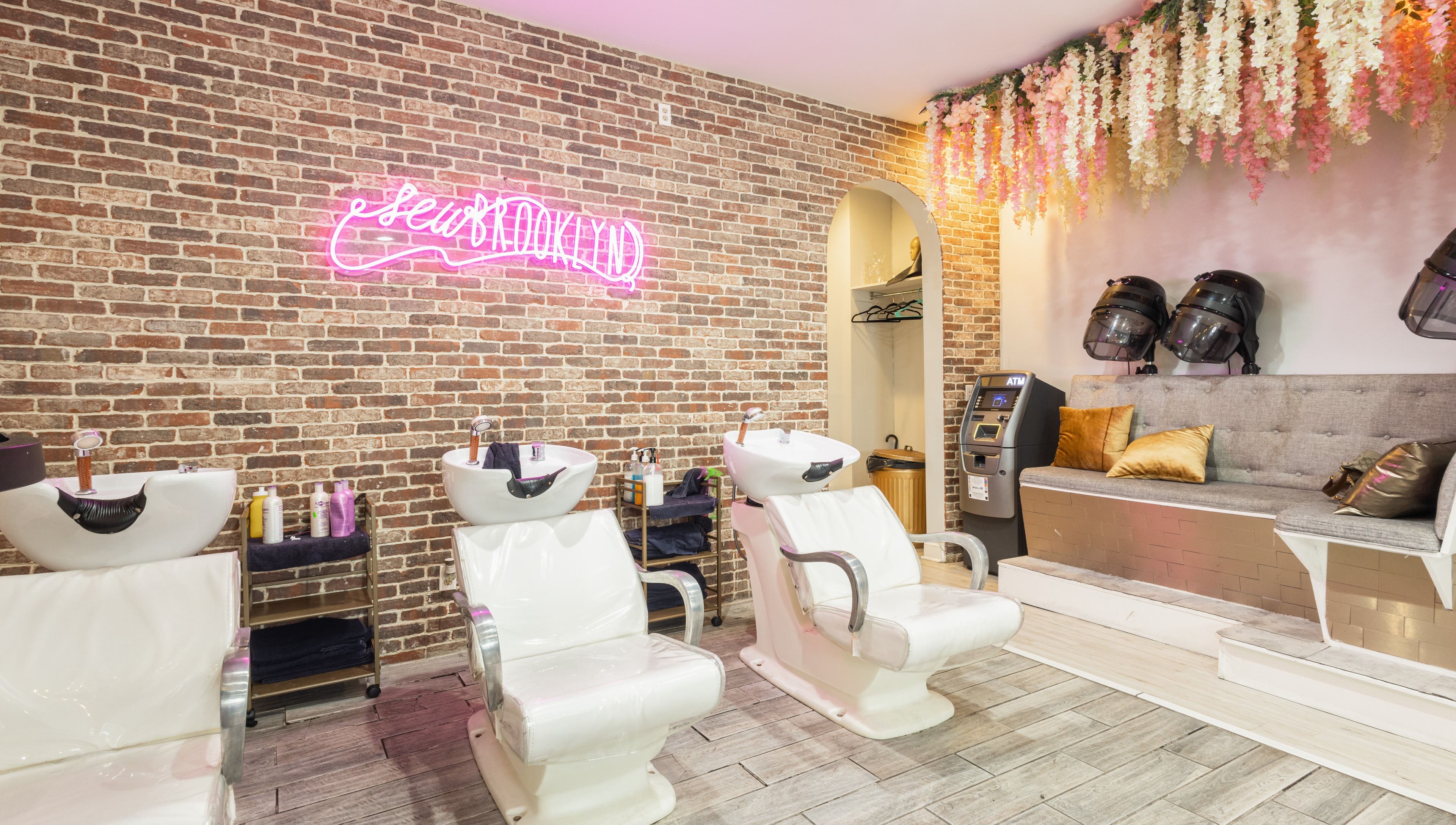 Modern hair washing area at Sew Brooklyn Hair Extension Lounge in New York, New York, US, with stylish decor.